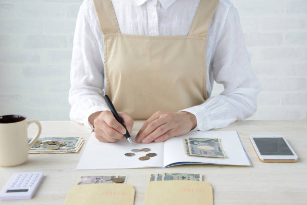 Japanese woman keeping household accounts with smart phone