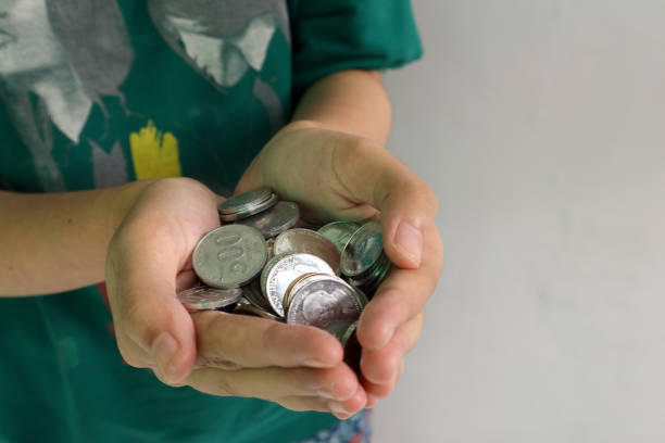 a woman collecting coins in both hands, in front of view point,